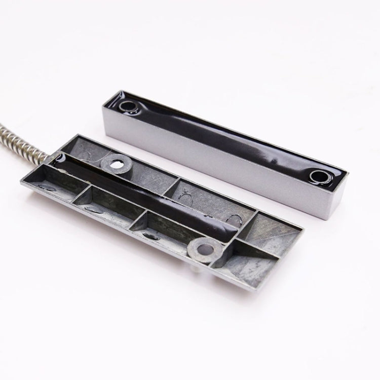 Magnetic sensor contacts with two metal pieces and coiled lead for door detection