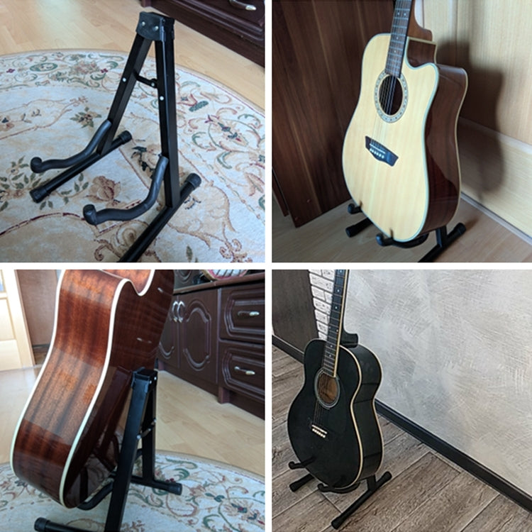 Foldable black metal guitar stand holding a light guitar in vertical position