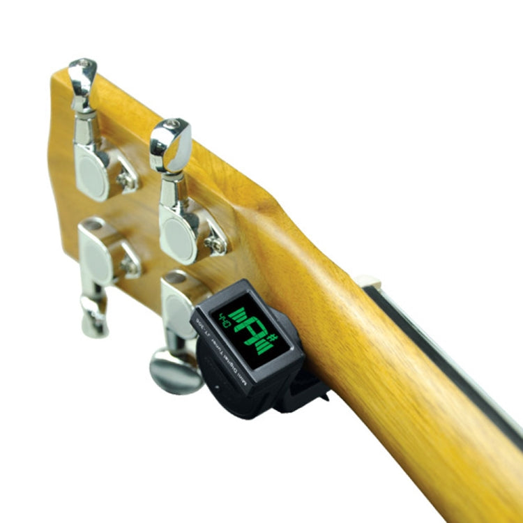 Clip-on tuner attached to wooden guitar headstock with green tuning display