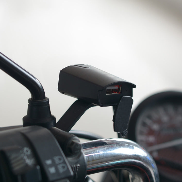 Black USB charger adapter mounted on motorcycle handlebar, red-lit single port