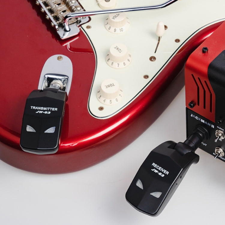 JW-03 receiver on black adapter near guitar knobs, plus transmitter unit