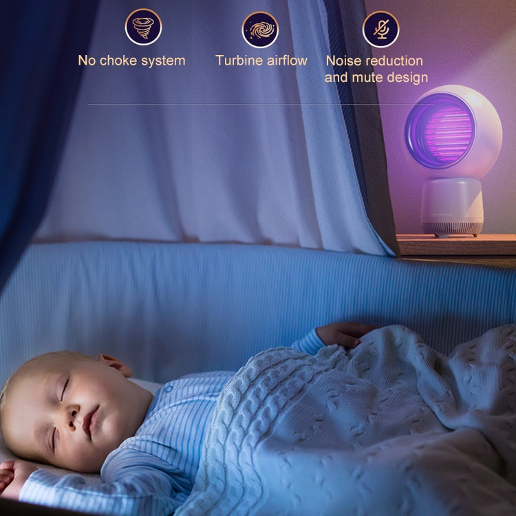 White mosquito killer lamp near a bed, with purple UV glow in the round top