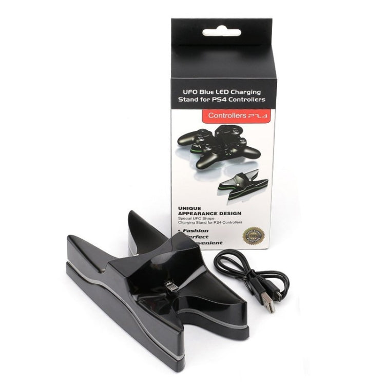 Black UFO charging dock with multicolor LEDs, USB cable, and retail box for controllers