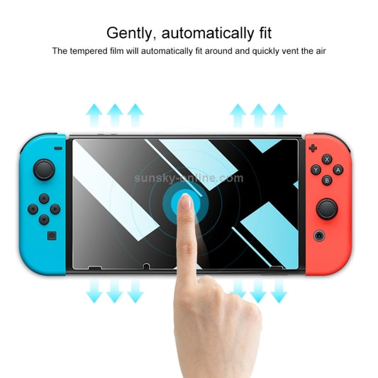 Screen protector film auto-fits on Switch Lite display, finger presses bubbles out