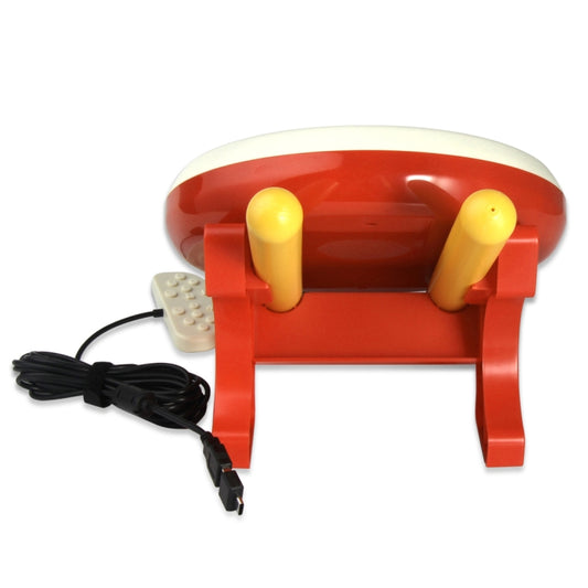 Taiko drum controller with red base, cream top, and two yellow drumsticks with controller