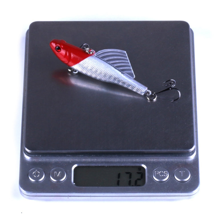 Red-and-silver pencil fishing lure on scale reading 17.2 g; two treble hooks