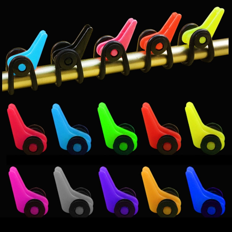 Assorted plastic fishing rod hook keeper clips in multiple colors on a gold rod