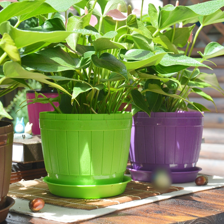 Green and purple plastic flower pots with matching trays, ridged barrel design