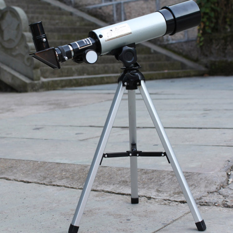 Astronomical telescope on tripod with silver tube and black viewfinder, angled view