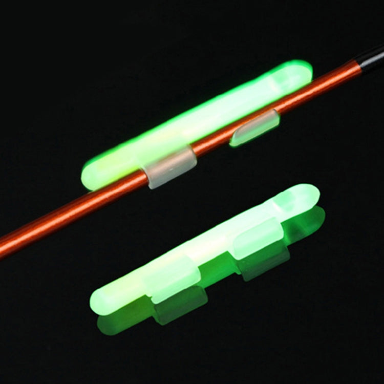 Clip-on luminous fishing light sticks glowing green on rod tip, translucent white and white clips
