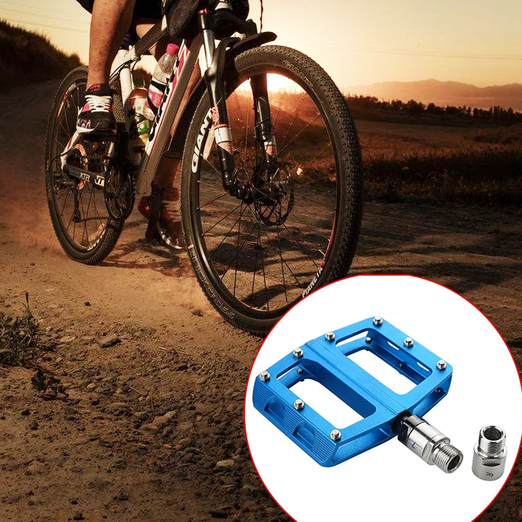 Steel pedal spacer extenders installed on a blue bike pedal, 9/16 threads