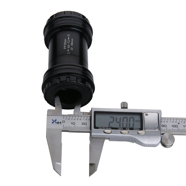 Black PF30 press-fit bottom bracket measured with caliper, display 24.00mm