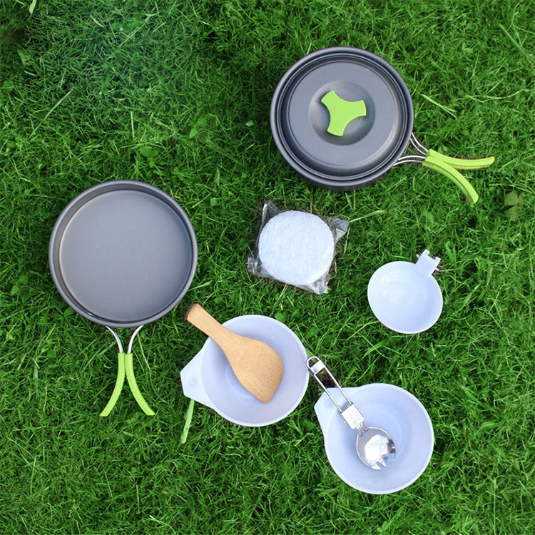 Camping cookware set with two collapsible pots, lid, and utensils, light gray and white.