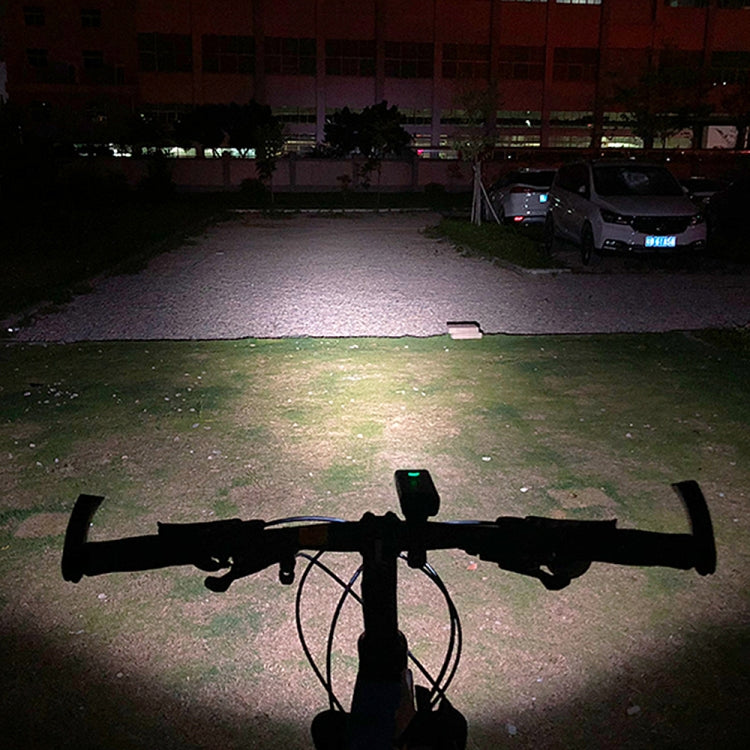 Front-mounted bicycle LED light on the handlebar, casting a wide beam