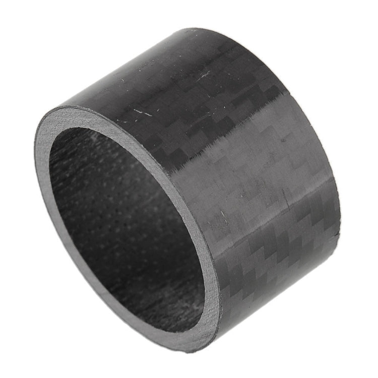 Single black carbon fiber headset spacer ring, close-up of woven texture and inner hole
