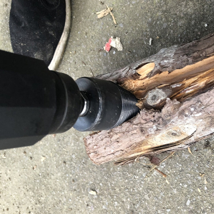 Electric wood splitting drill bit in use on firewood, tapered fluted head