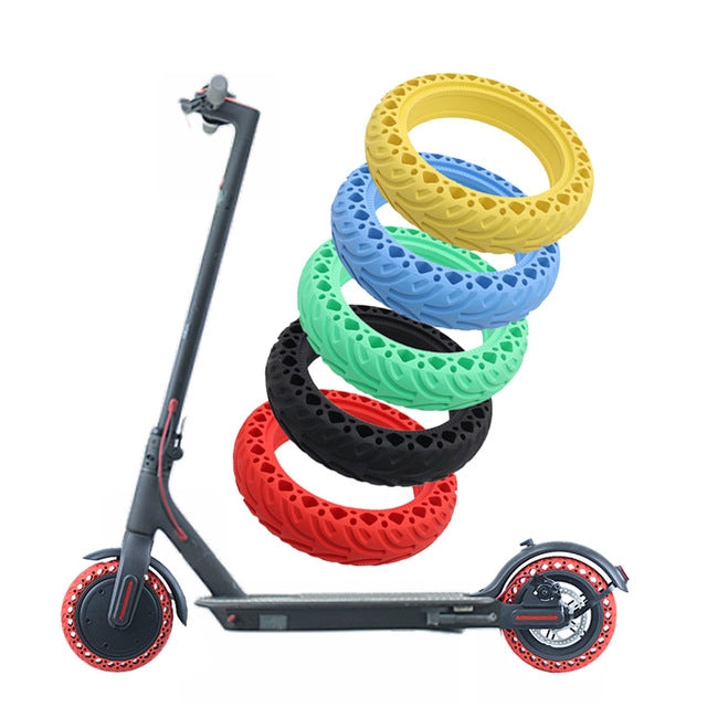 Electric scooter shown with multiple colorful solid tires stacked above the wheels
