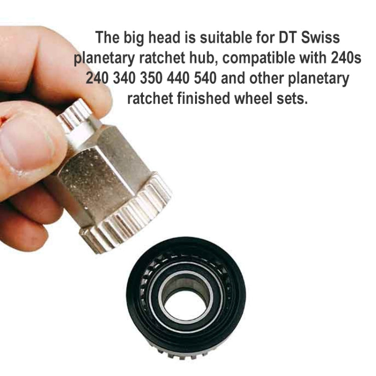 Held metal ratchet tool head with serrated teeth and adjacent black toothed wheel part