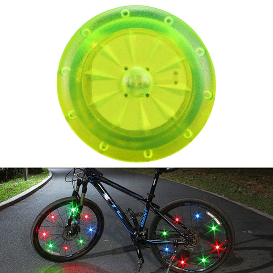 Green glowing clip-on safety light disc for night riding on children’s bikes