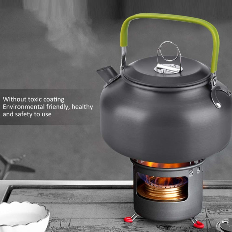 Portable camping kettle on camp stove burner, dark-gray body with lime-green handle