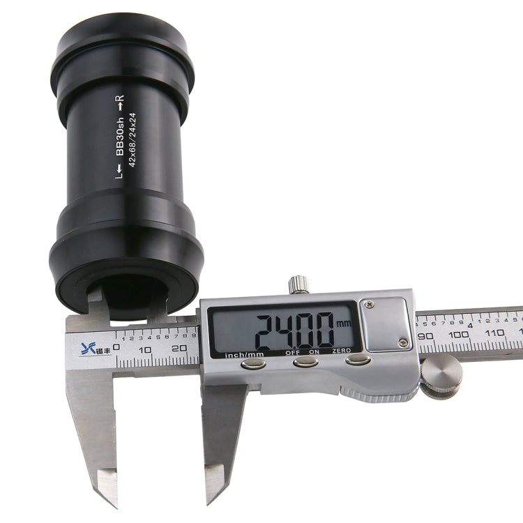 Black BB30 press-fit bottom bracket measured with caliper, close-up of distance