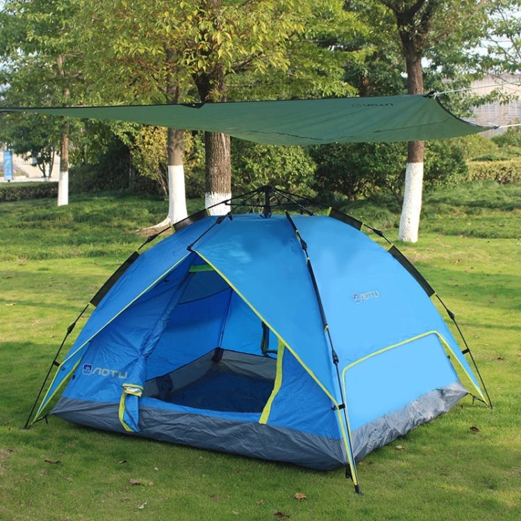 Blue camping tent on outdoor grass with groundsheet underneath