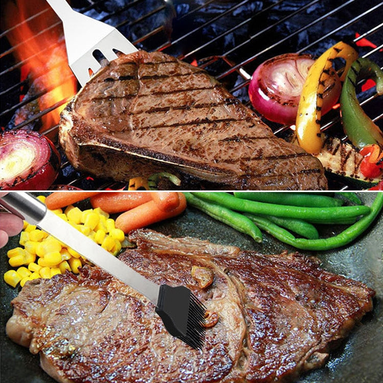 Stainless grilling spatula and fork tools serving meat and vegetables on a hot grill
