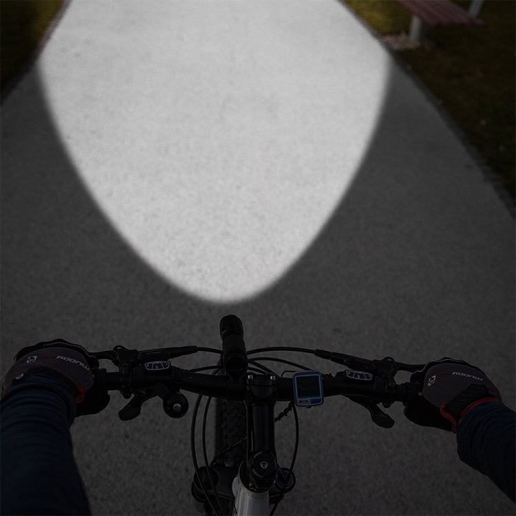 Bicycle handlebars with faint front white light and rear red taillight illuminated