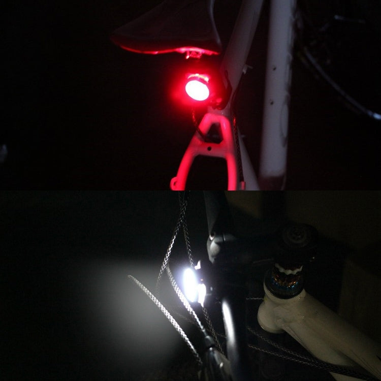 Bicycle front and rear lights lit: white head LED and red rear taillight LED.