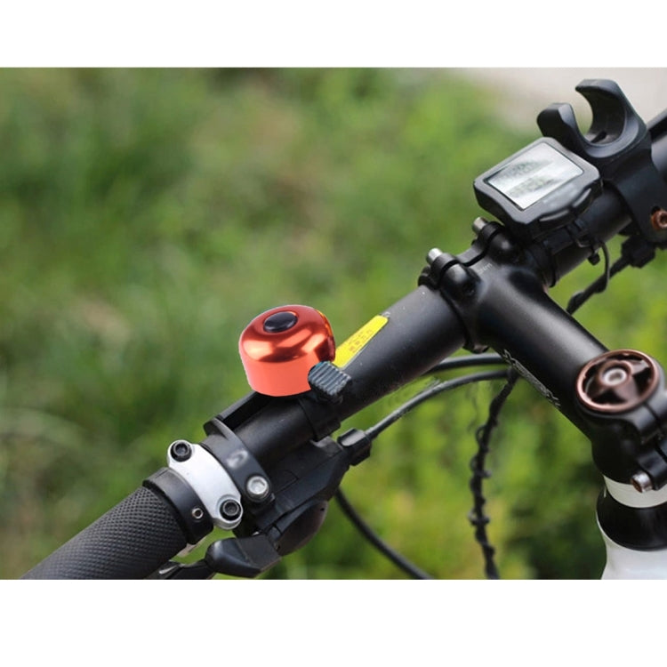Installed mini bicycle bell ring with red alloy bell on handlebars