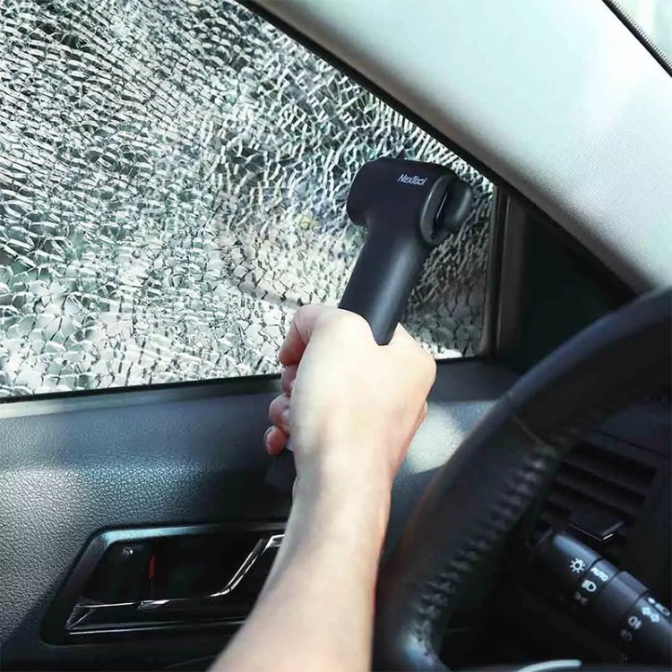 Emergency survival hammer held toward a car window, shining white light on glass