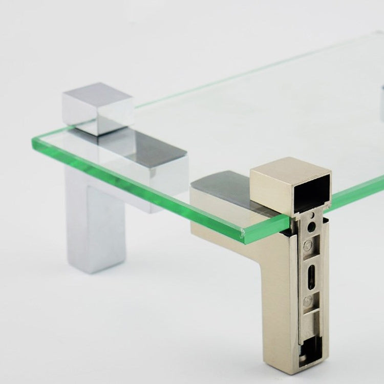 Fixed glass clip bracket securing a glass shelf corner with metal side housing