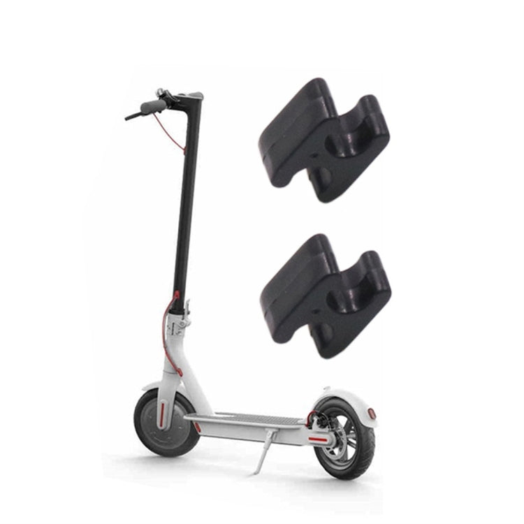 Black brake cable clasp clips installed on electric scooter frame