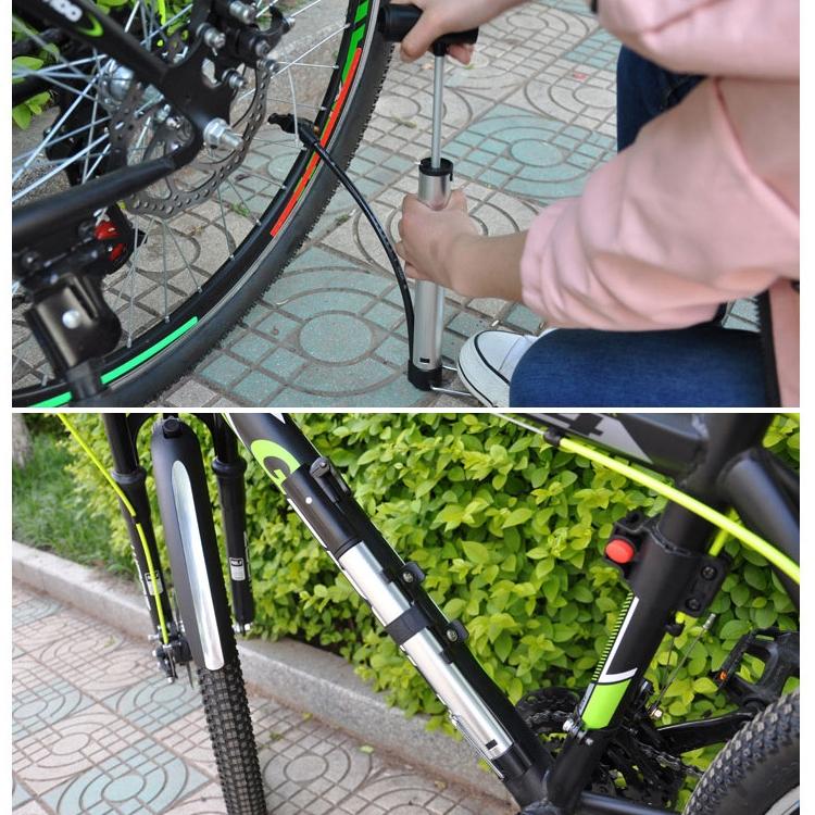 Bicycle air pump connected to tire valve with black head and silver aluminum cylinder