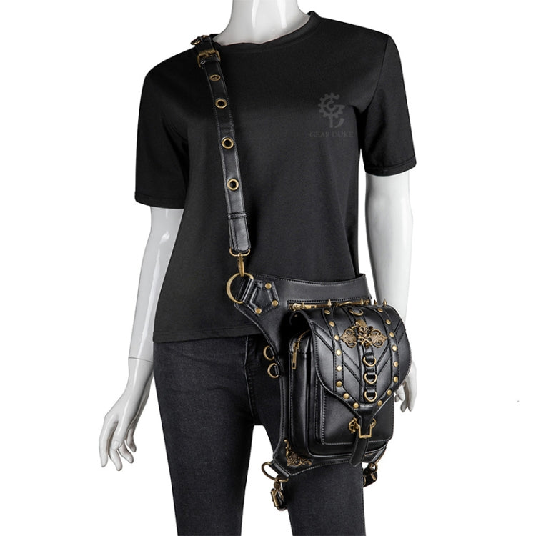 Black PU leather skull crossbody bag worn at the hip with gold-tone strap and belt buckles