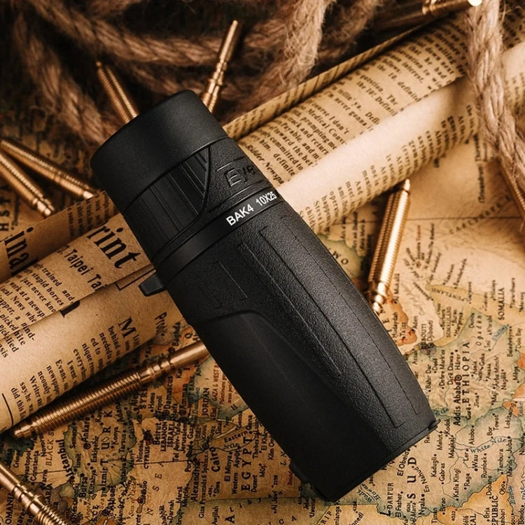 Black monocular lying on vintage paper with nearby metallic rounds