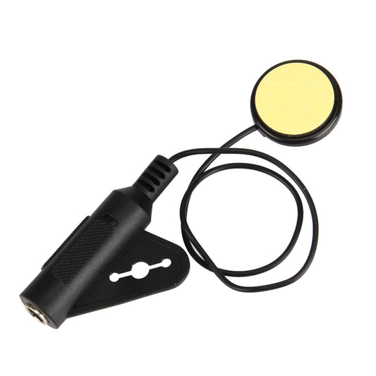 Clip-on guitar tuner with yellow circular back and black triangular clamp