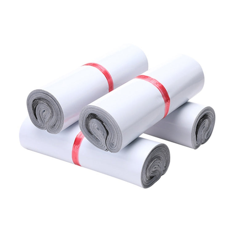 Rolled white padded mailing bags, bundled with red bands and gray backing layers