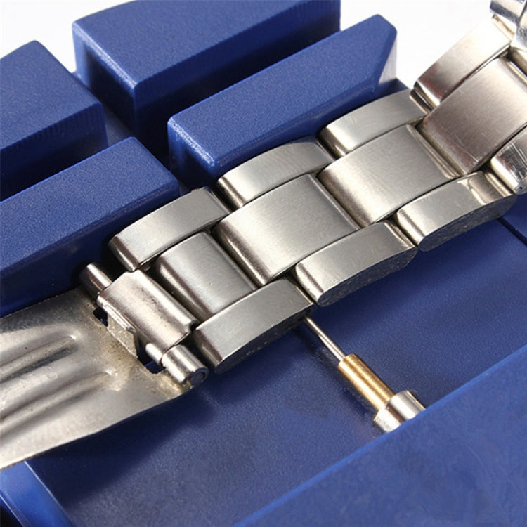 Watch strap adjuster tool pressing a metal bracelet link