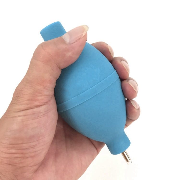 Blue rubber air blower held in hand for watch cleaning
