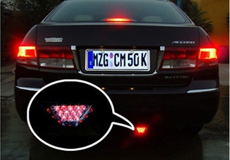 Red triangular 12-LED brake warning light on the rear of a car