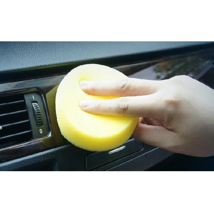 Yellow foam sponge ball for car interior cleaning, held in a hand