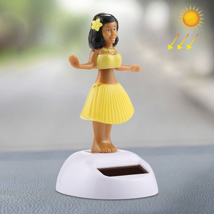 Solar bobble-head hula dancer ornament with yellow skirt on white solar base
