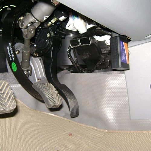 ELM327 OBDII WiFi scanner connected to a car OBD port under dashboard