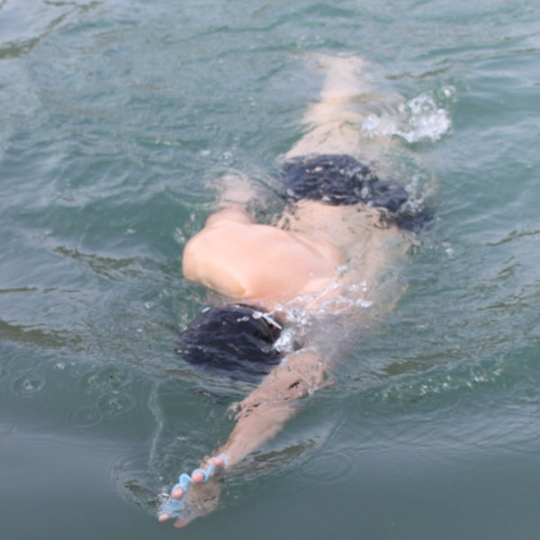 Swimmer wearing light blue silicone swim web fin hand flippers during swim