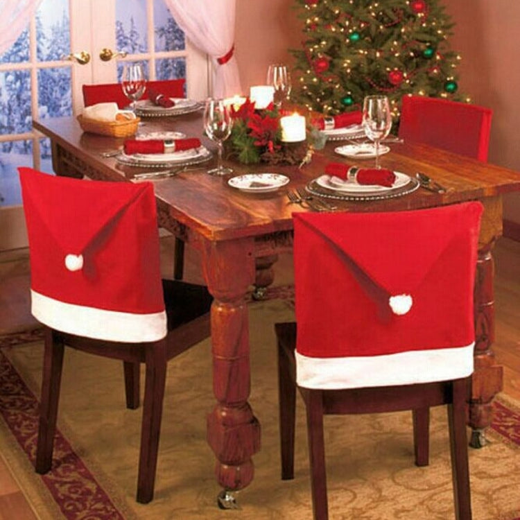 Pair of red and white Christmas chair covers with folded top and pom-pom accents