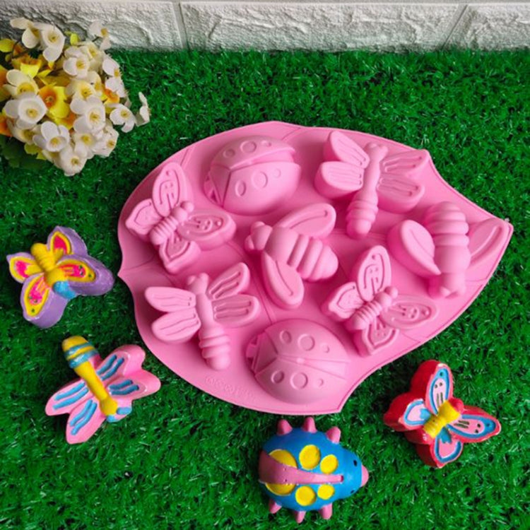 Pink insect-themed silicone cake mold with butterfly and bug cavity shapes