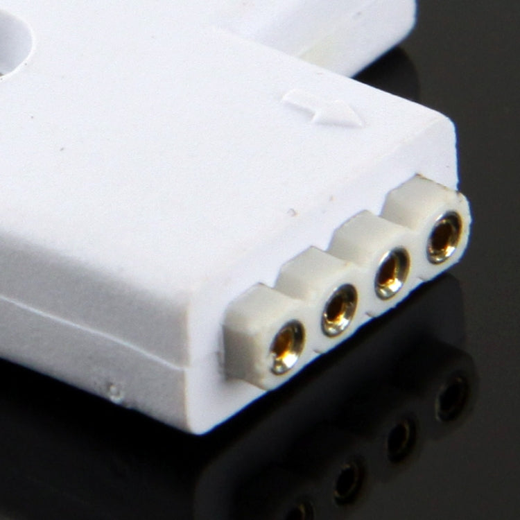 Close-up of white 4-pin female LED connector terminals with four gold contact pins