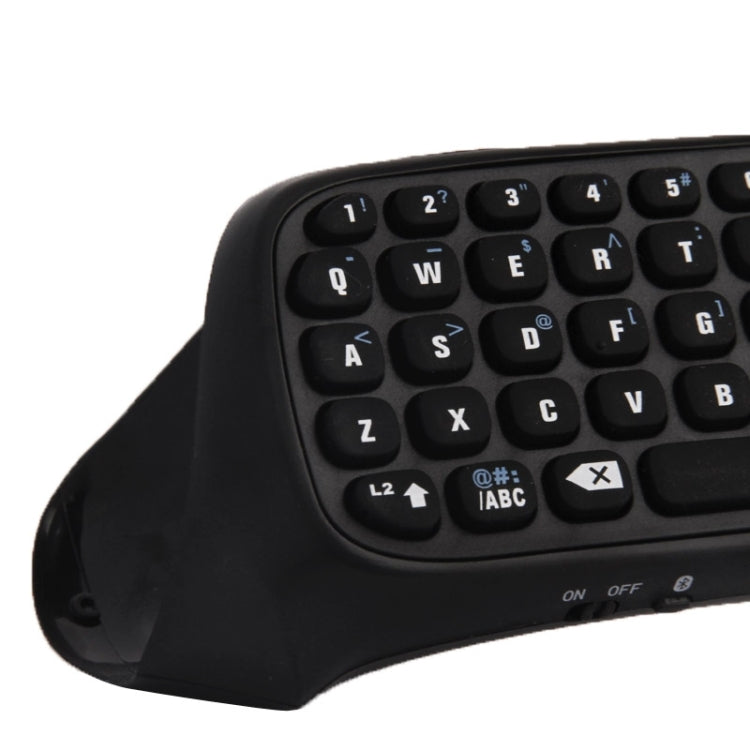 Black wireless mini keyboard close-up of QWERTY keys and function icons
