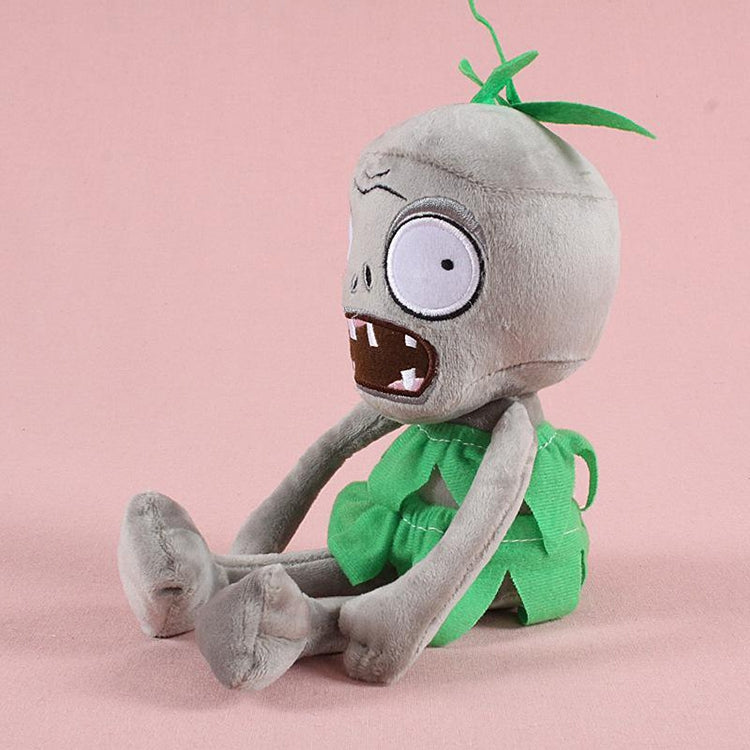 Plush zombie doll seated with legs forward, wearing green ragged dress and leaf tuft
